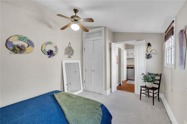 carpeted bedroom featuring a closet, ceiling fan, and lofted ceiling