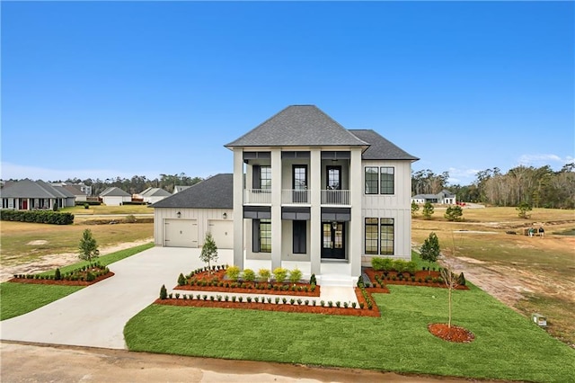 view of front of home featuring a balcony, a front lawn, and a garage