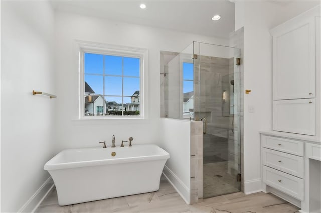 bathroom featuring independent shower and bath