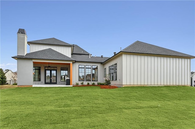 rear view of house featuring french doors and a yard