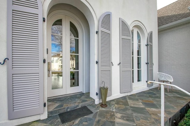 view of exterior entry featuring french doors