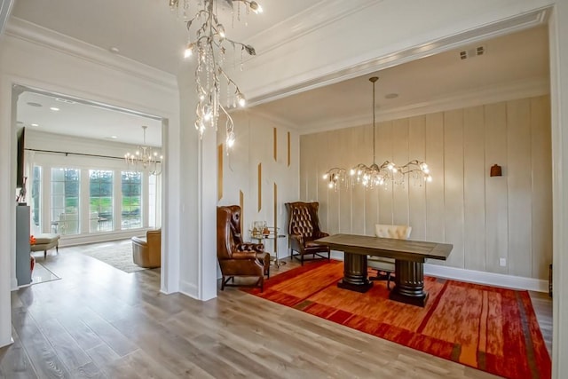 dining area featuring an inviting chandelier, crown molding, and hardwood / wood-style floors