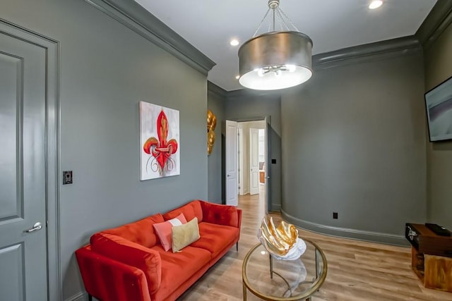 living room with crown molding and light wood-type flooring