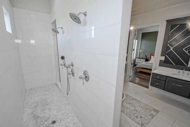 bathroom with vanity, tile patterned floors, and tiled shower