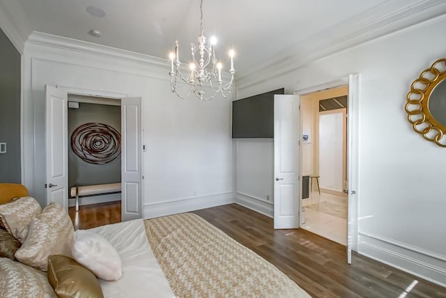 bedroom with dark hardwood / wood-style flooring, ornamental molding, and a notable chandelier