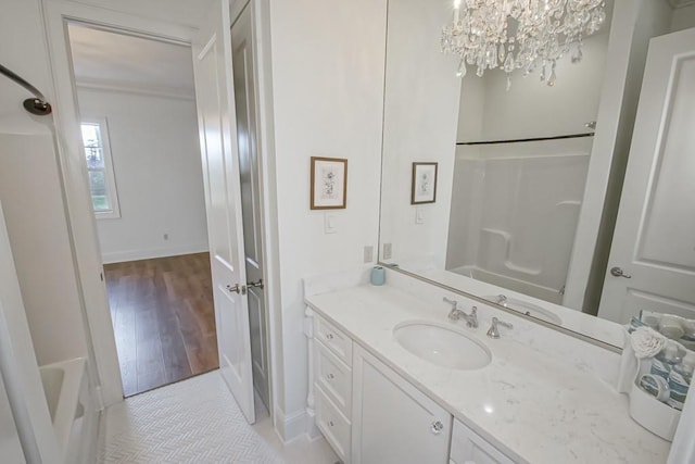 bathroom with vanity, independent shower and bath, an inviting chandelier, and hardwood / wood-style flooring