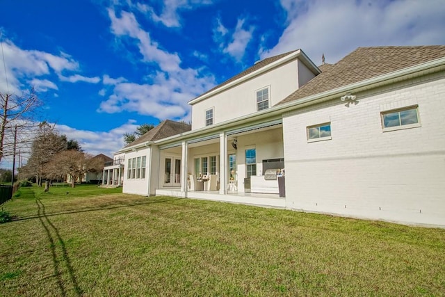 rear view of property with a lawn