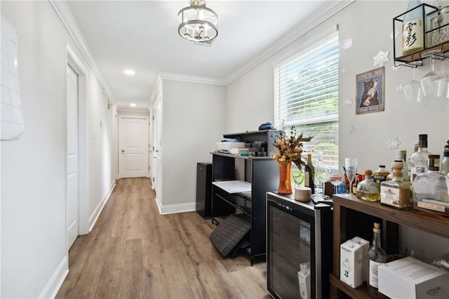 hall with hardwood / wood-style floors, plenty of natural light, ornamental molding, and wine cooler