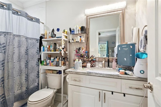 bathroom with vanity, toilet, and ceiling fan