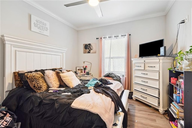 bedroom featuring ceiling fan, light hardwood / wood-style floors, and ornamental molding