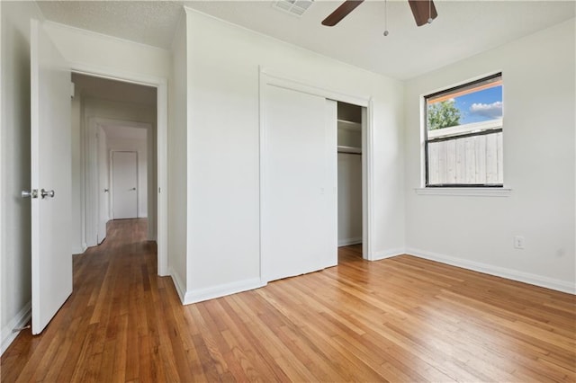 unfurnished bedroom with a closet, ceiling fan, and hardwood / wood-style floors