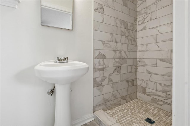 bathroom with a tile shower