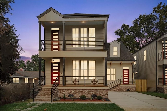 contemporary house with a porch and a balcony