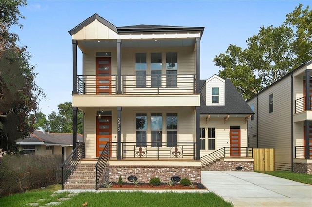 view of front of property with a balcony and covered porch