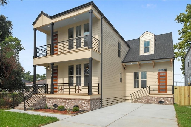 contemporary house with a porch and a balcony