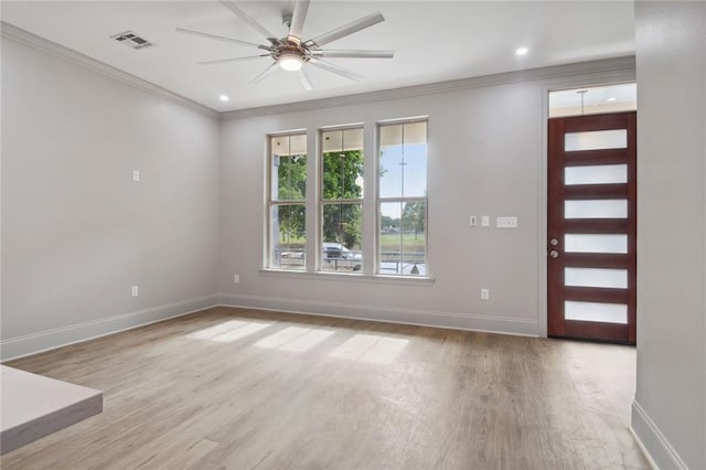 entrance foyer featuring ceiling fan, ornamental molding, and light hardwood / wood-style floors