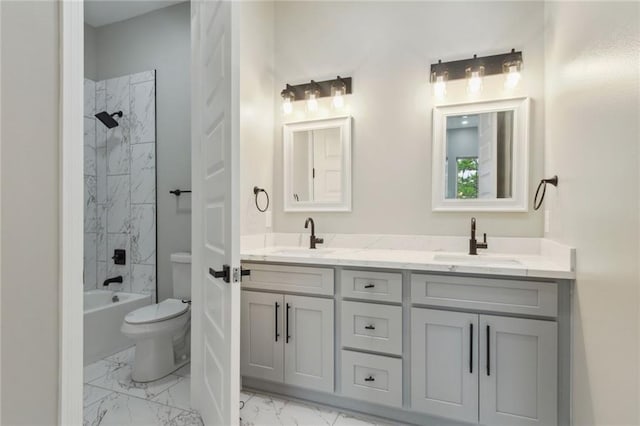 full bathroom featuring toilet, tiled shower / bath, and vanity