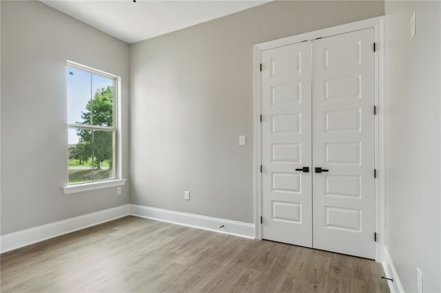 interior space featuring light wood-type flooring and plenty of natural light