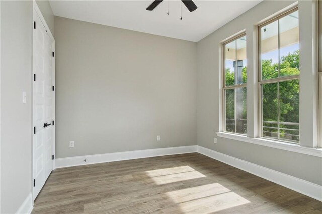 unfurnished room featuring ceiling fan and hardwood / wood-style floors