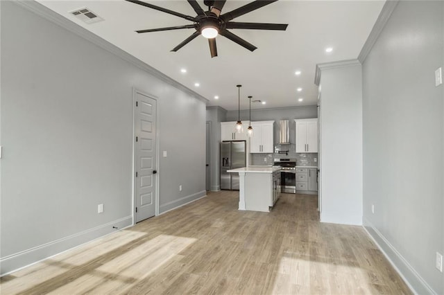 unfurnished living room with ceiling fan, ornamental molding, and light hardwood / wood-style floors