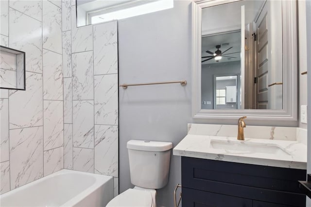 full bathroom featuring toilet, vanity, ceiling fan, and bathtub / shower combination