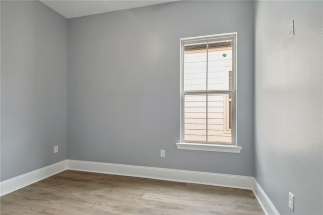 empty room with light hardwood / wood-style flooring