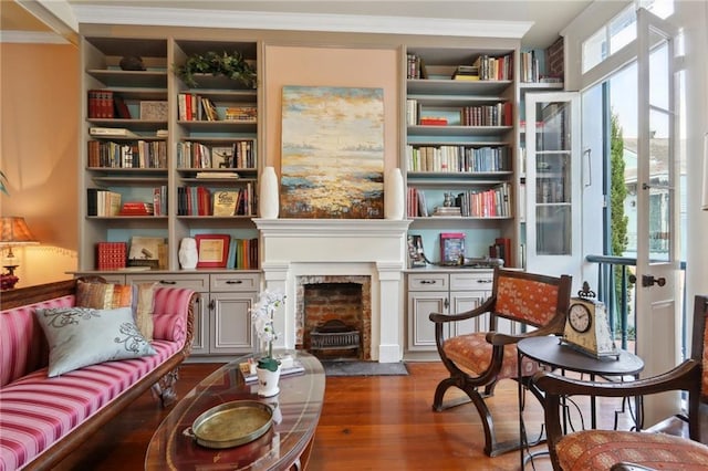 sitting room featuring crown molding and dark wood-type flooring