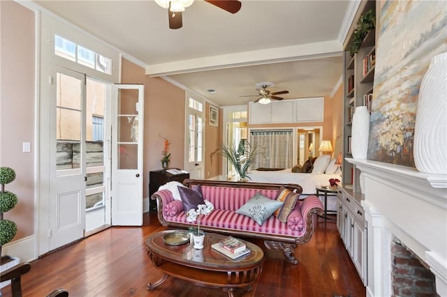 sunroom featuring beam ceiling and ceiling fan