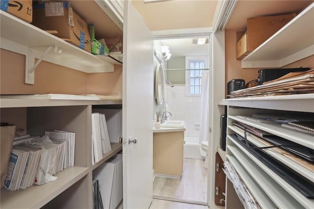 full bathroom featuring hardwood / wood-style floors, toilet, sink, and bathing tub / shower combination