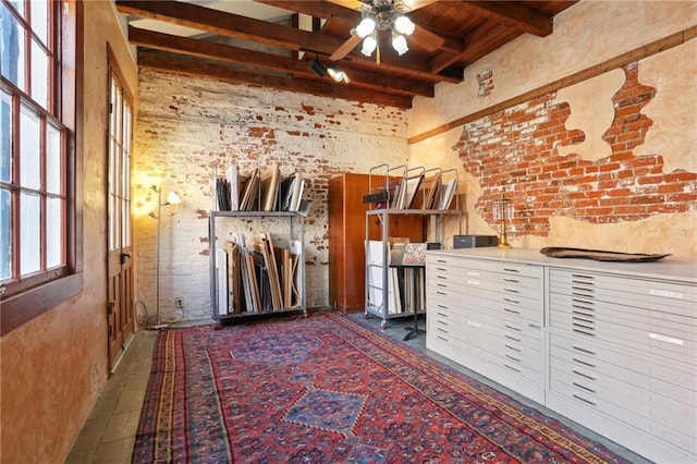 interior space featuring a wealth of natural light, beamed ceiling, wooden ceiling, and ceiling fan