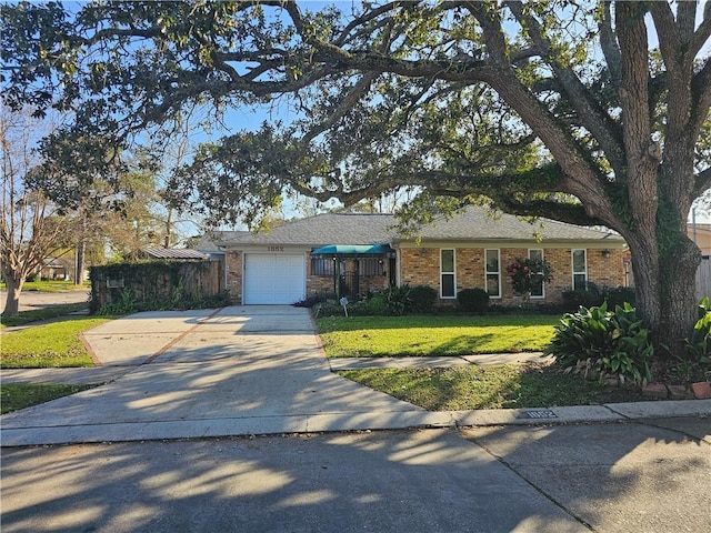 ranch-style home featuring a front lawn and a garage