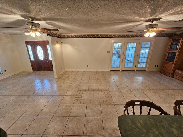 tiled foyer entrance featuring ceiling fan