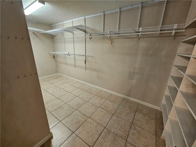 walk in closet featuring tile patterned flooring