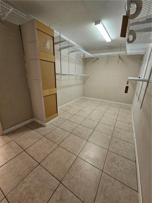 spacious closet featuring light tile patterned floors