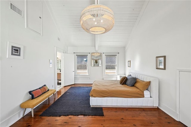 bedroom with beamed ceiling, wood ceiling, and dark wood-type flooring