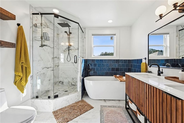 full bathroom with shower with separate bathtub, vanity, toilet, and tile walls