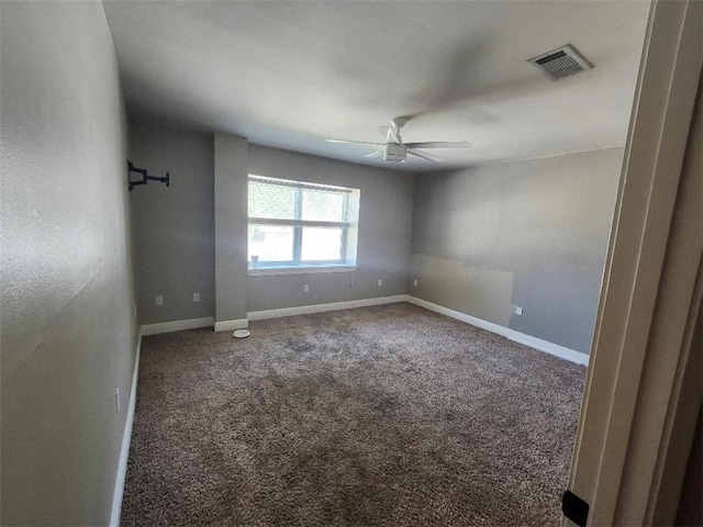 empty room featuring carpet flooring and ceiling fan