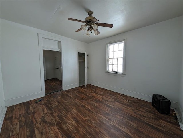 unfurnished bedroom featuring ceiling fan and dark hardwood / wood-style flooring