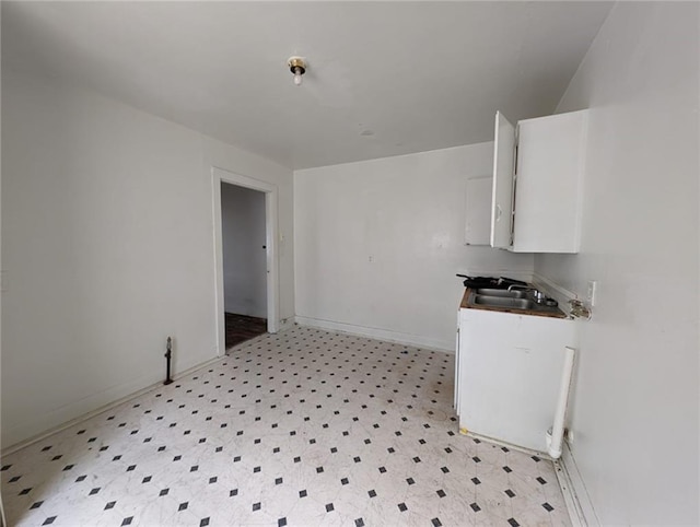 kitchen featuring sink and white cabinetry