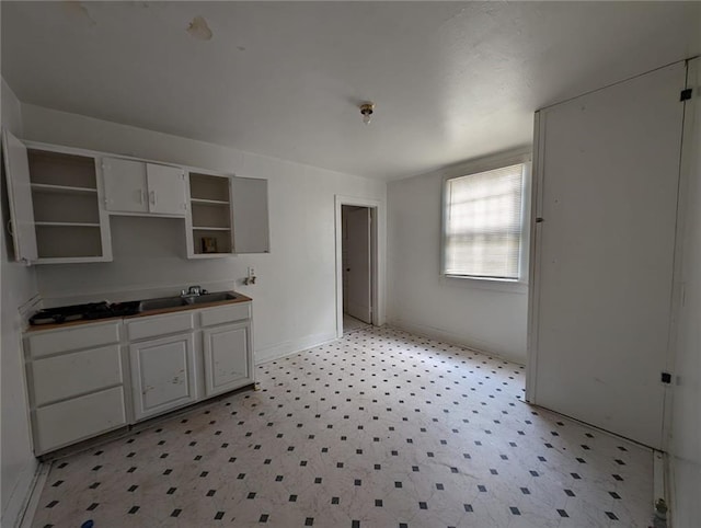 kitchen featuring sink and white cabinets