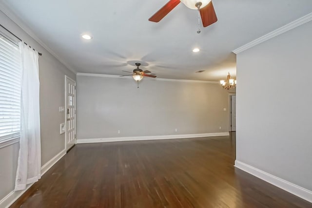 empty room featuring crown molding, dark hardwood / wood-style floors, and an inviting chandelier