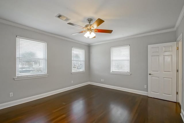 spare room with crown molding, dark wood-type flooring, and ceiling fan