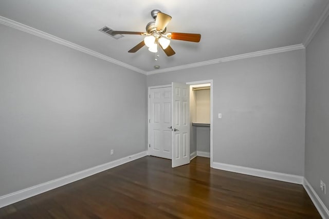 unfurnished bedroom with dark wood-type flooring, ornamental molding, and ceiling fan