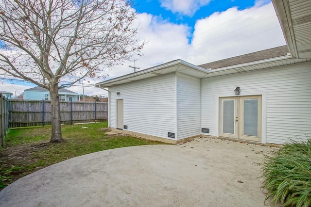 rear view of house featuring french doors, a yard, and a patio