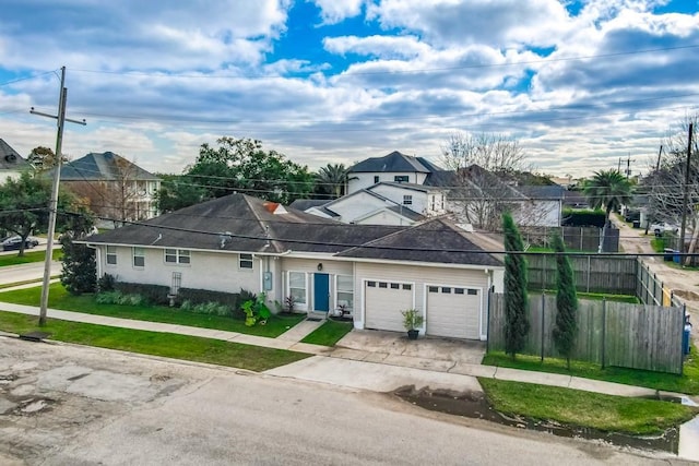 ranch-style home featuring a garage and a front yard