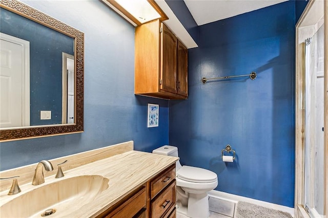 bathroom featuring tile patterned floors, vanity, and toilet