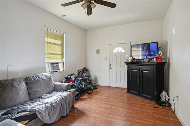 living room with hardwood / wood-style flooring, ceiling fan, and cooling unit