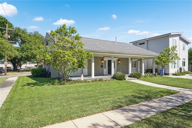 view of front of house with covered porch and a front lawn