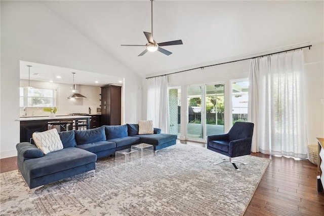 living room featuring ceiling fan, dark hardwood / wood-style flooring, high vaulted ceiling, and sink