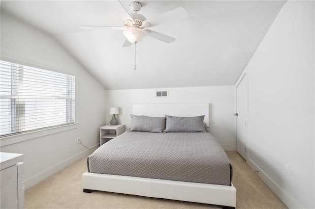 bedroom featuring light carpet, vaulted ceiling, and ceiling fan